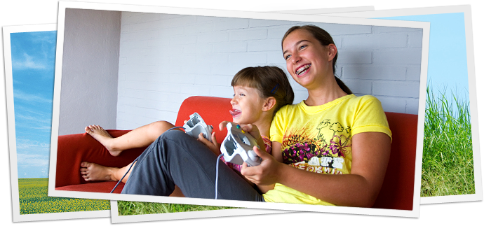 photo of two girls on couch playing video game